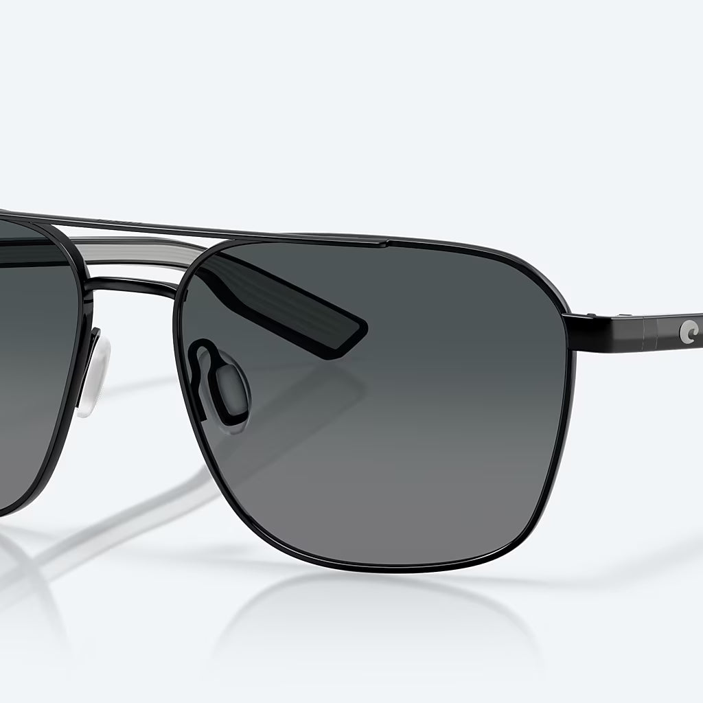 Costa Wader polarized sunglasses with black metal frame and gray lenses, angled view