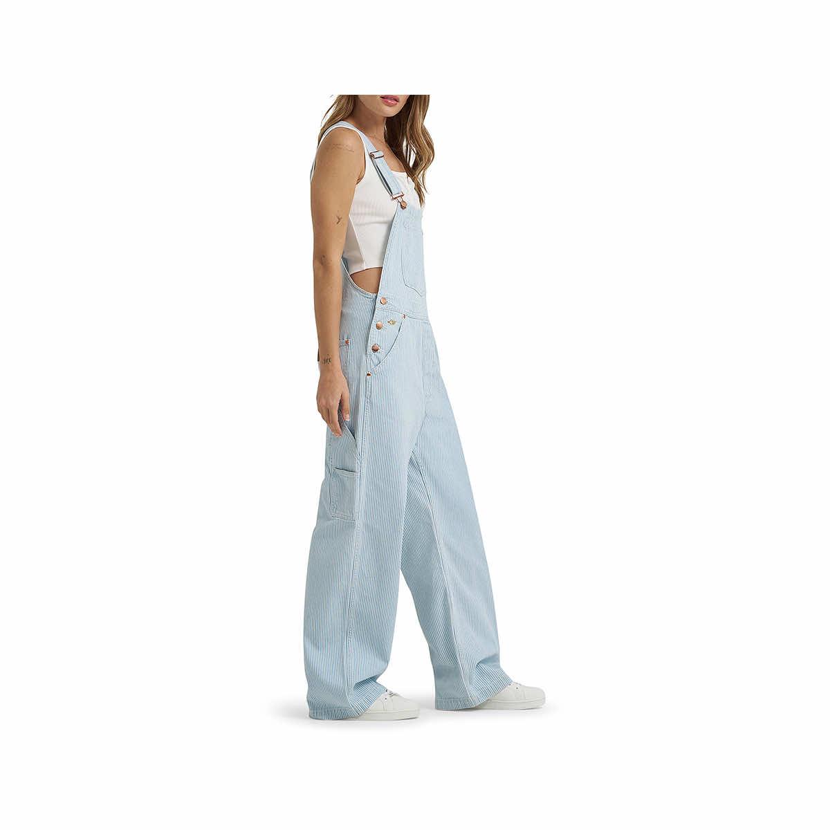 Light blue denim overalls worn by a person on a white background