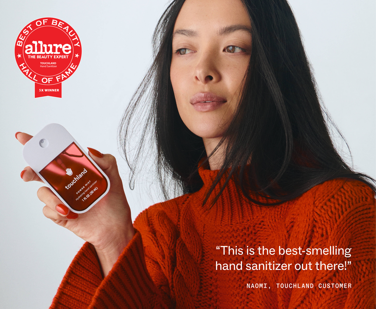 Model holding Touchland Cranberry Fizz Power Mist with Allure Best of Beauty badge