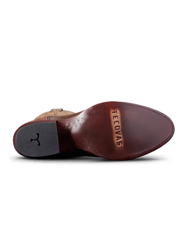 Brown leather shoe sole with 'Tecovas' branding on a white background