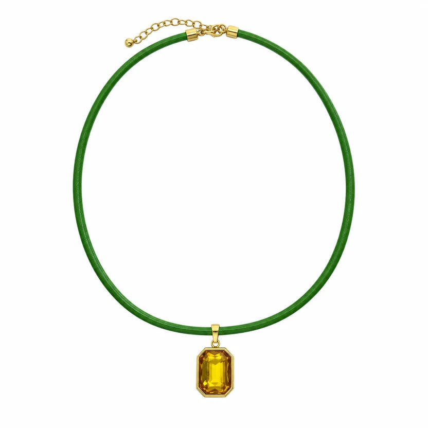 Quin Pendant Necklace in green cord with yellow jewel pendant on a white background