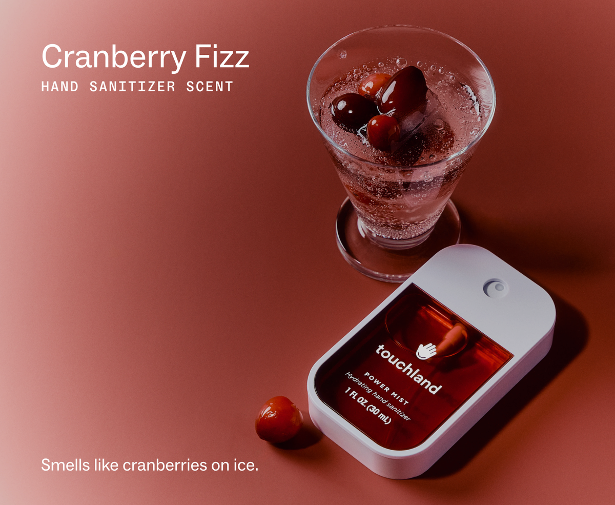 Touchland Cranberry Fizz Power Mist with a glass of cranberries, scent label graphic