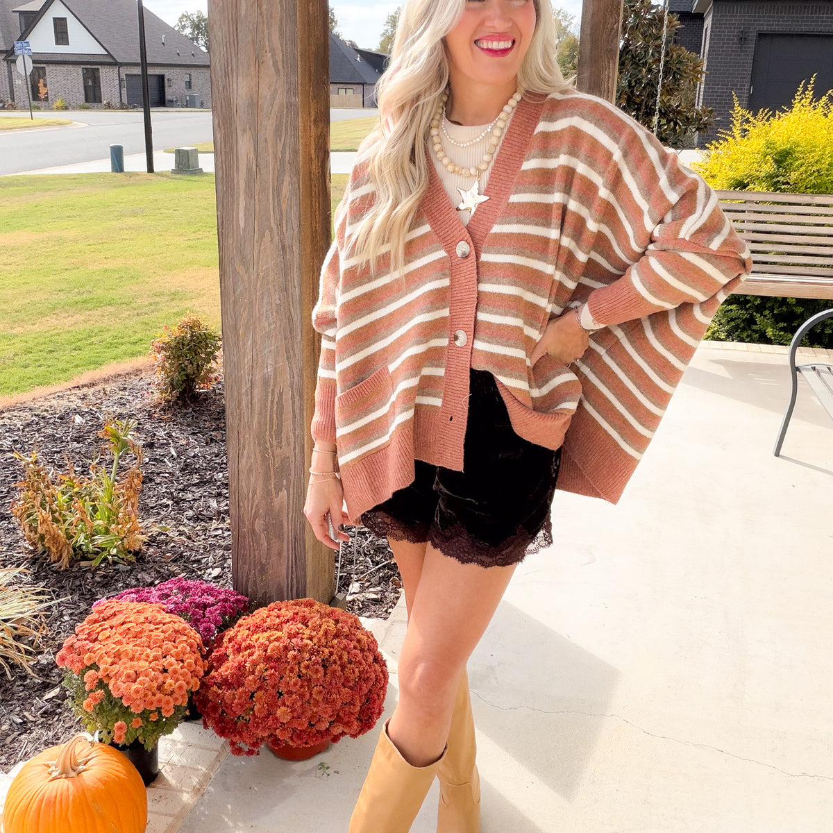 Oversized Camel Multi striped cardigan with a button front, styled with a black lace-trim skirt and tan boots.