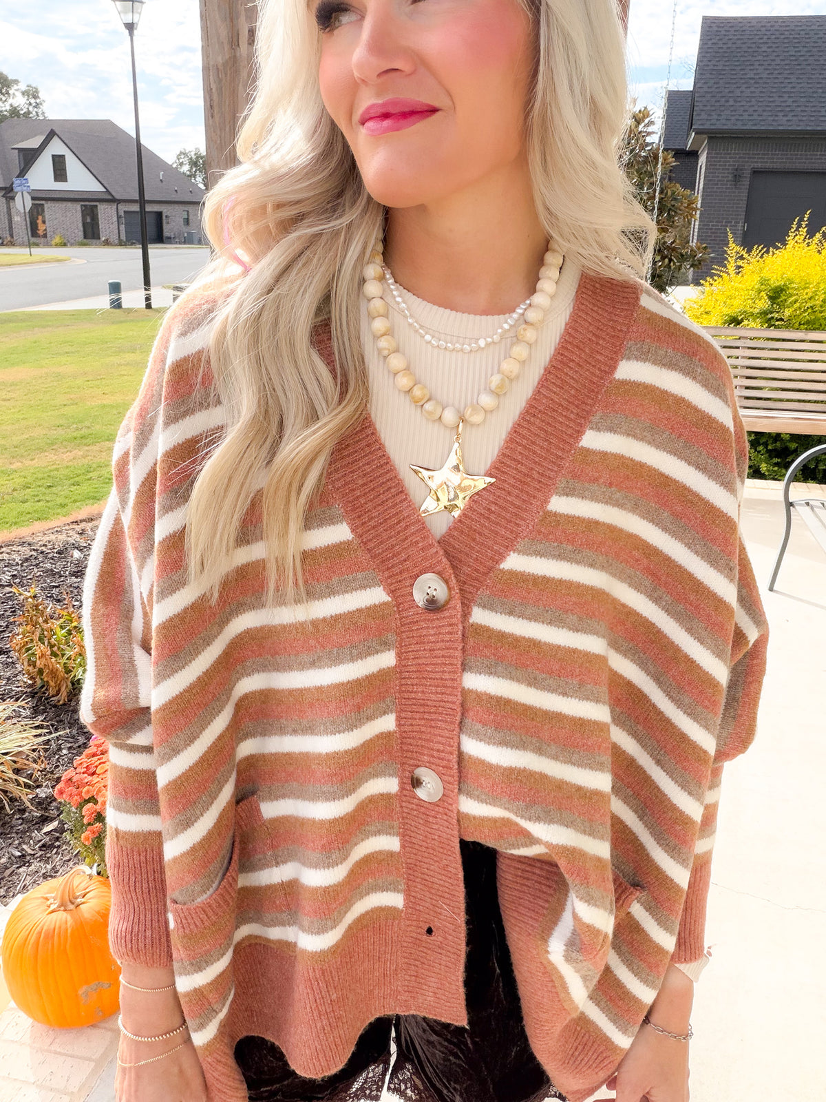 Close-up of the Camel Multi striped cardigan showing textured knit, ribbed V-neck trim and button front.