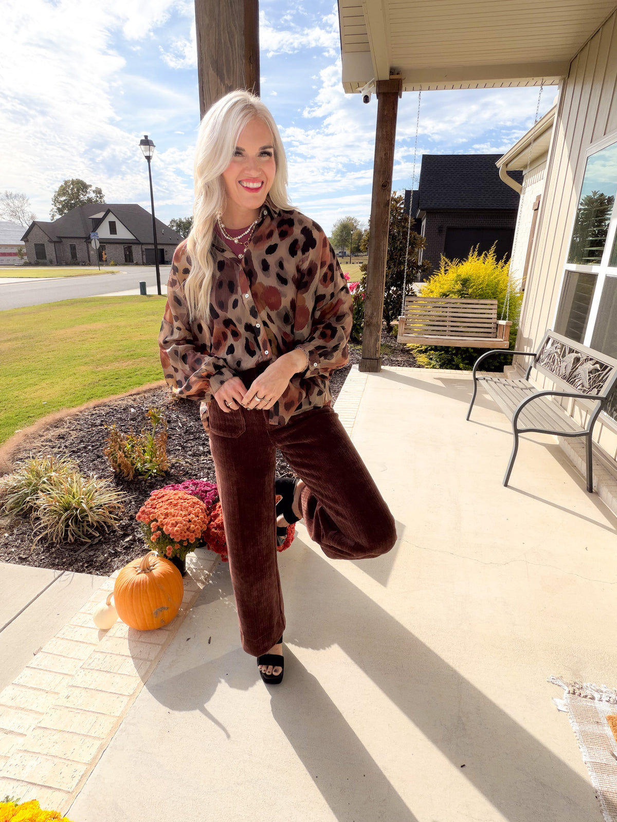 Brown Multi leopard print sheer button down shirt styled with brown wide-leg trousers and black heels.