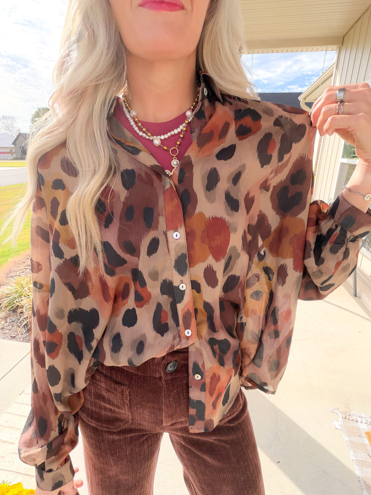 Close-up of the Brown Multi leopard print sheer shirt showing its collar, button front and lightweight woven fabric.