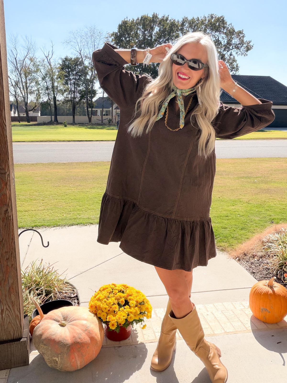 Chocolate brown corduroy dress with puff sleeves and ruffle hem, styled with tan boots and a green neck scarf