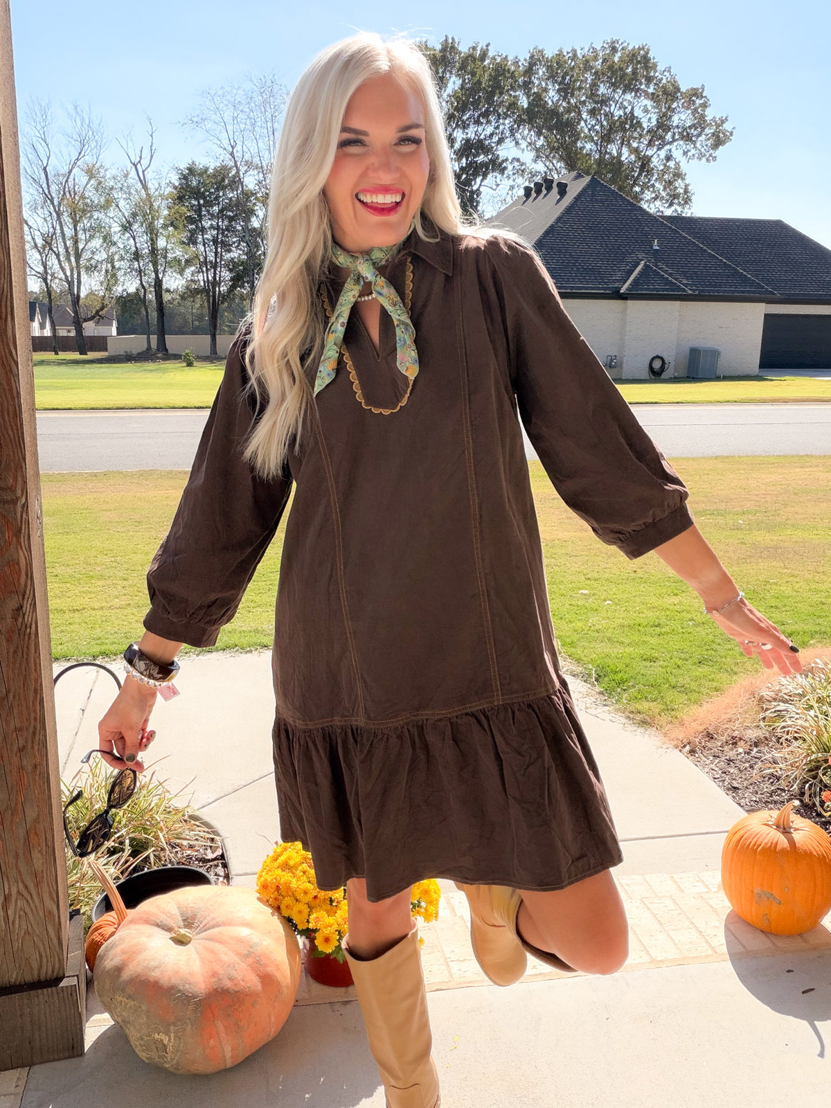 Chocolate brown corduroy dress with three-quarter puff sleeves extended and a gathered ruffle hem