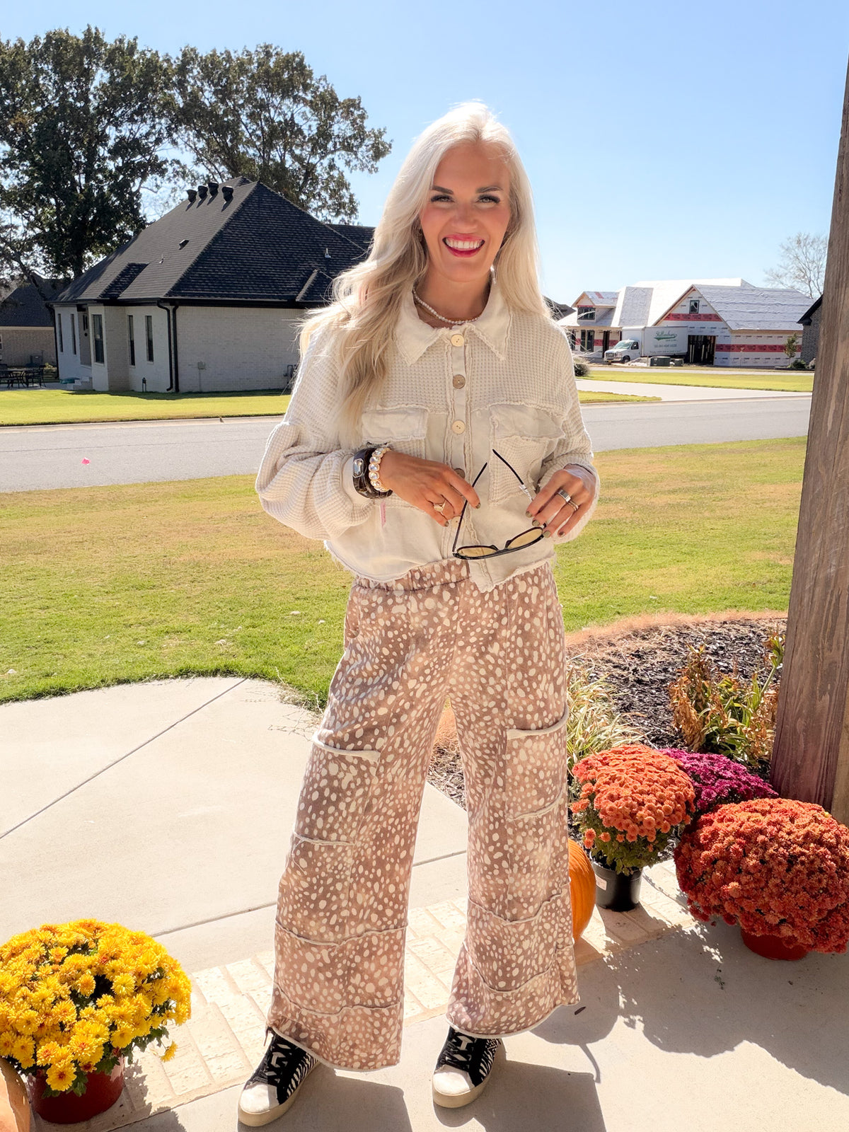 Chilliest Hour women's natural shacket buttoned up with printed wide-leg pants and sneakers.