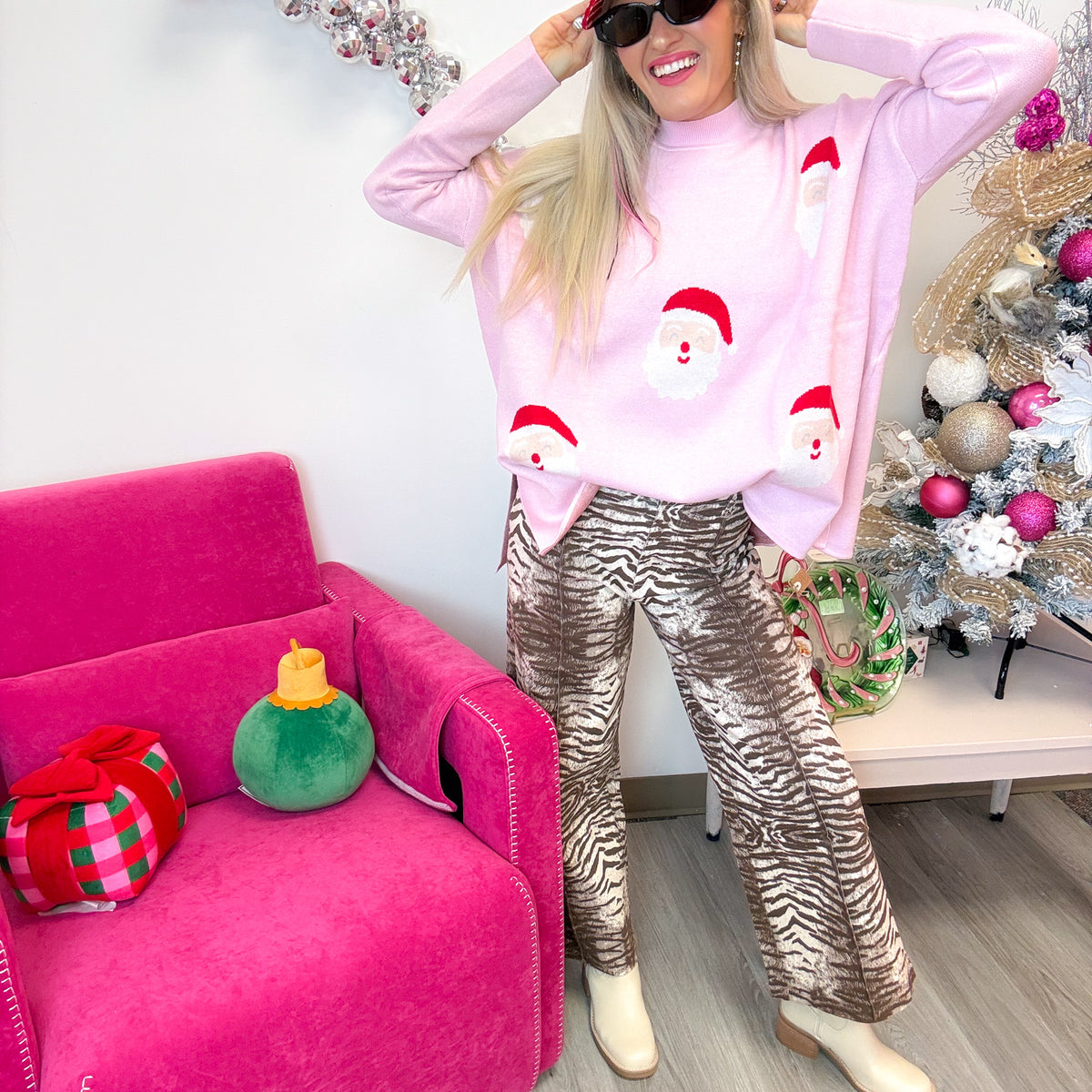 Mud Pie pink Santa jacquard sweater worn loose over zebra print pants, full-length front view