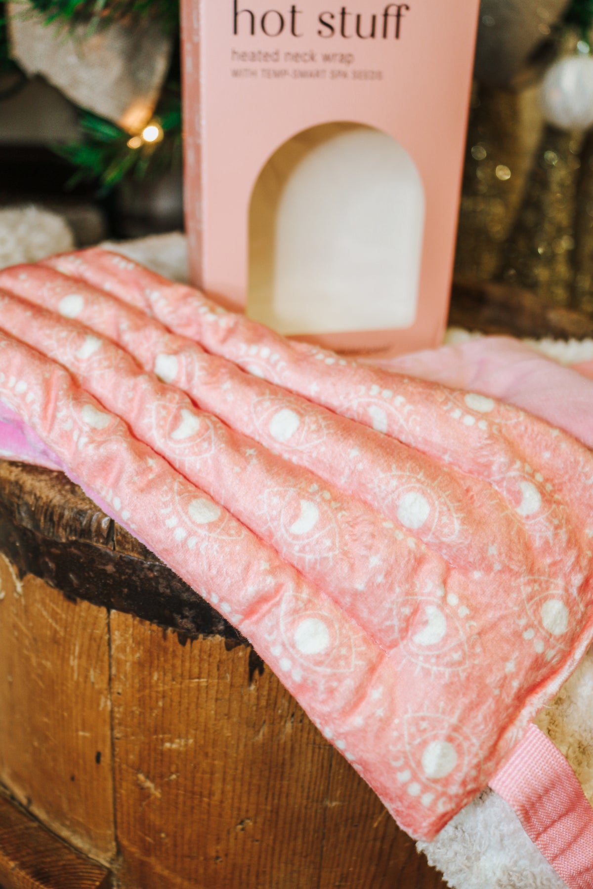 Hot Stuff Heated Neck Wrap in light pink, close-up of the quilted print and straps