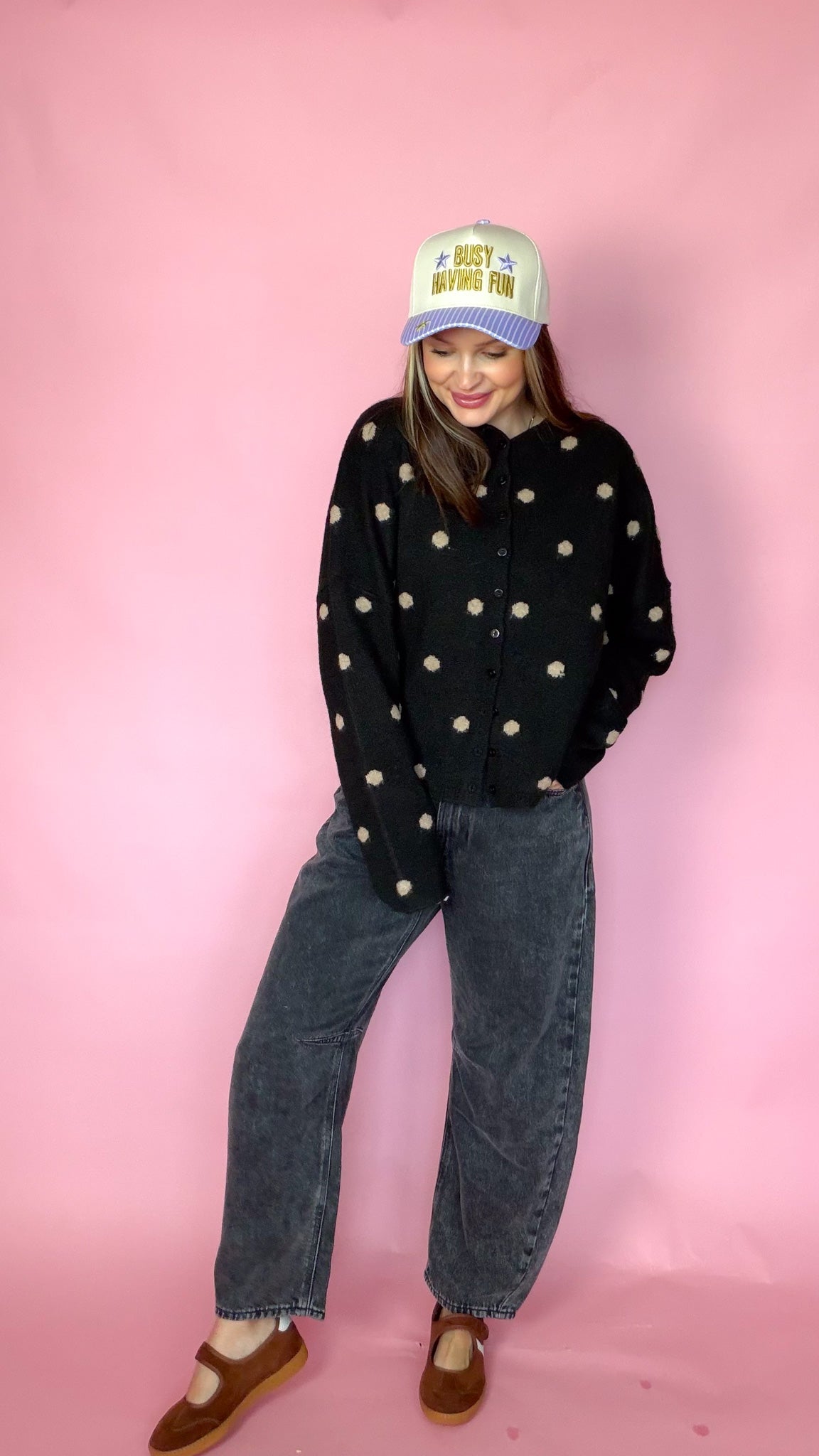 At A Glance black polka dot sweater, front view with hands in pockets