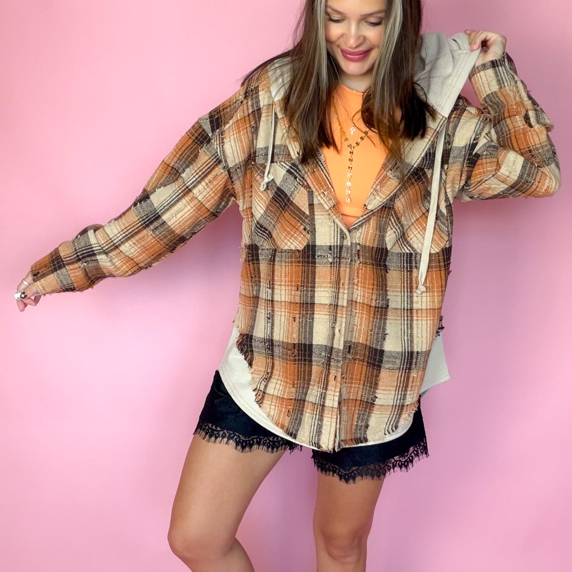 Good Company Hoodie Plaid Flannel in orange and brown worn open over an orange tee
