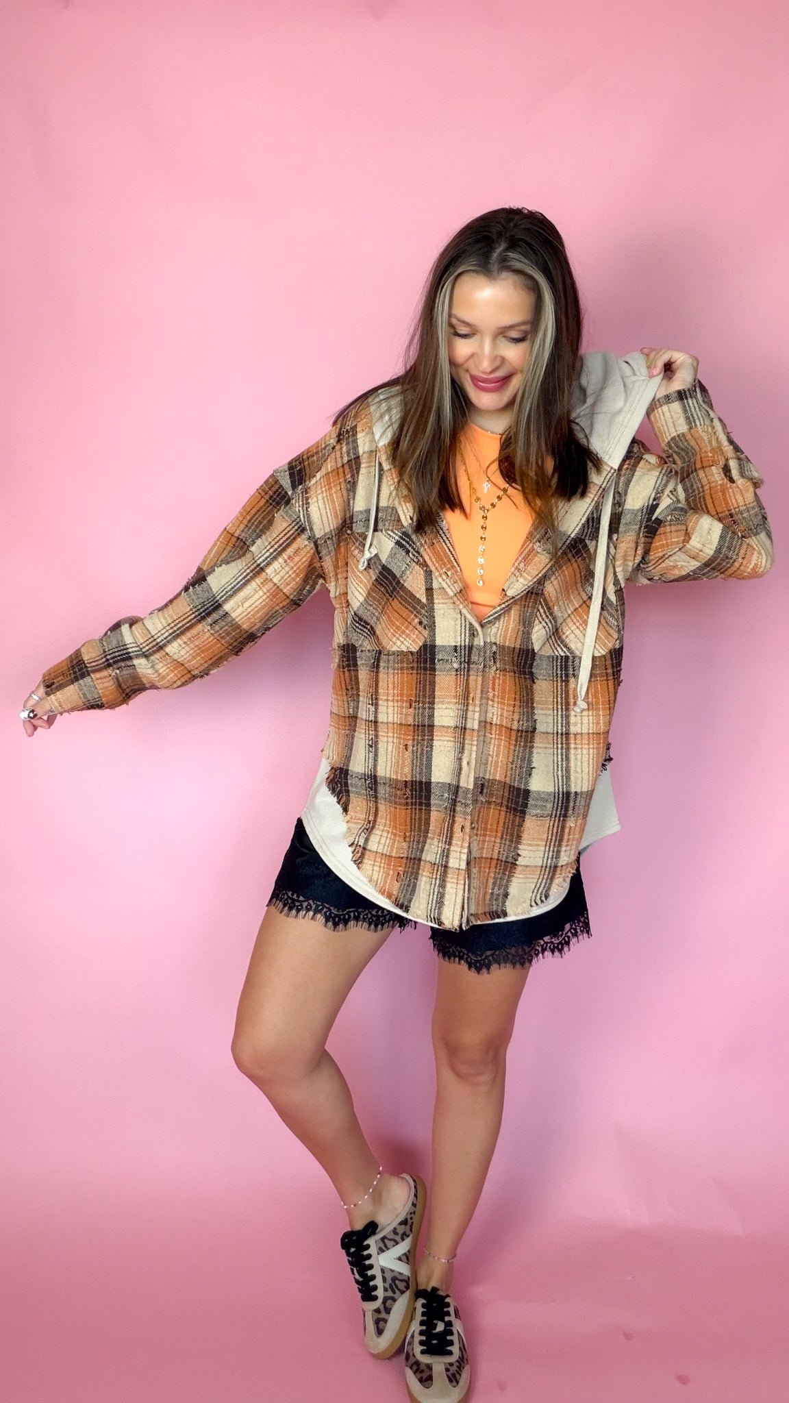 Good Company Hoodie Plaid Flannel in orange and brown worn open over an orange tee