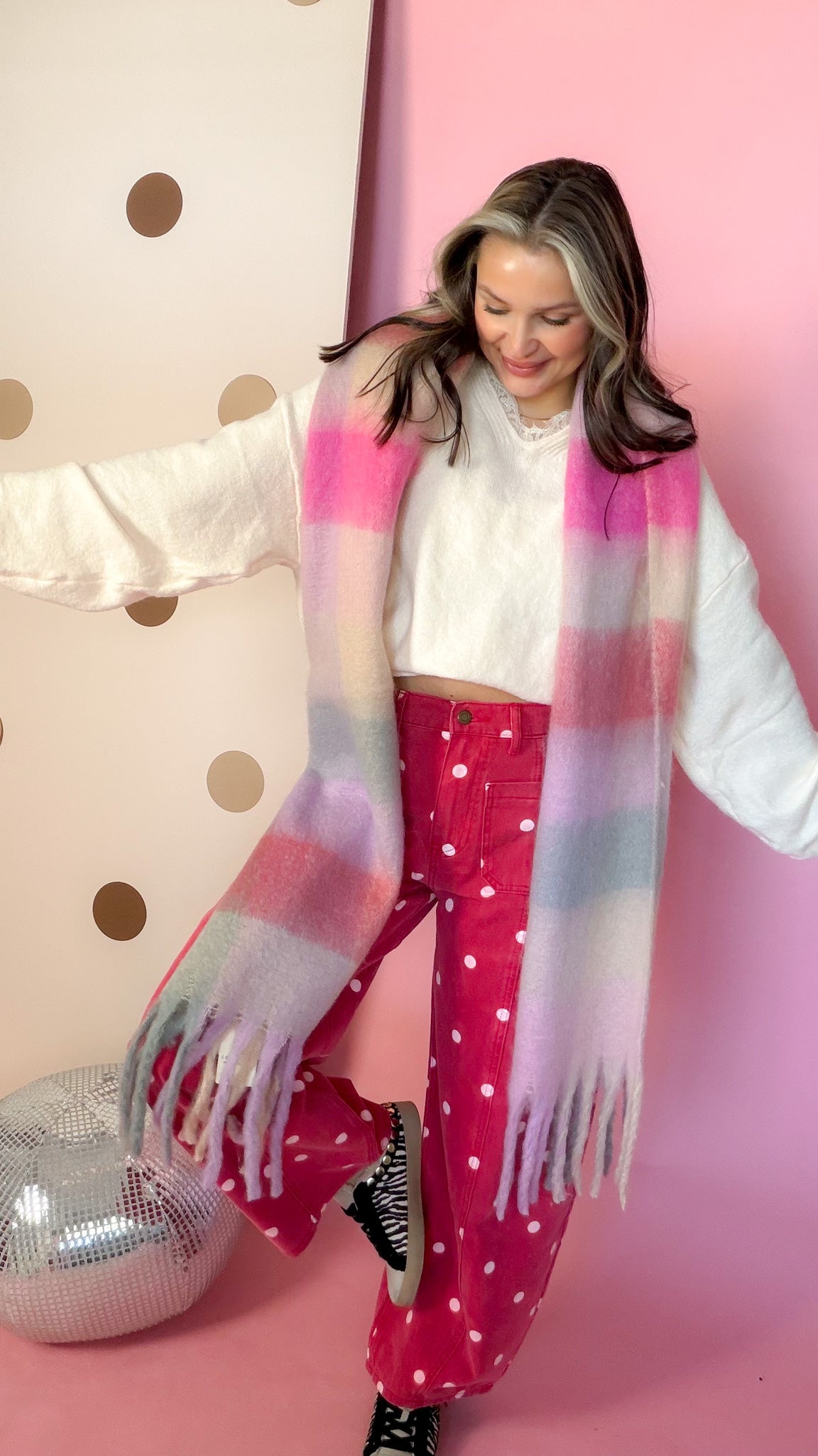 Joia plaid pink chunky scarf, model posing with leg kicked up