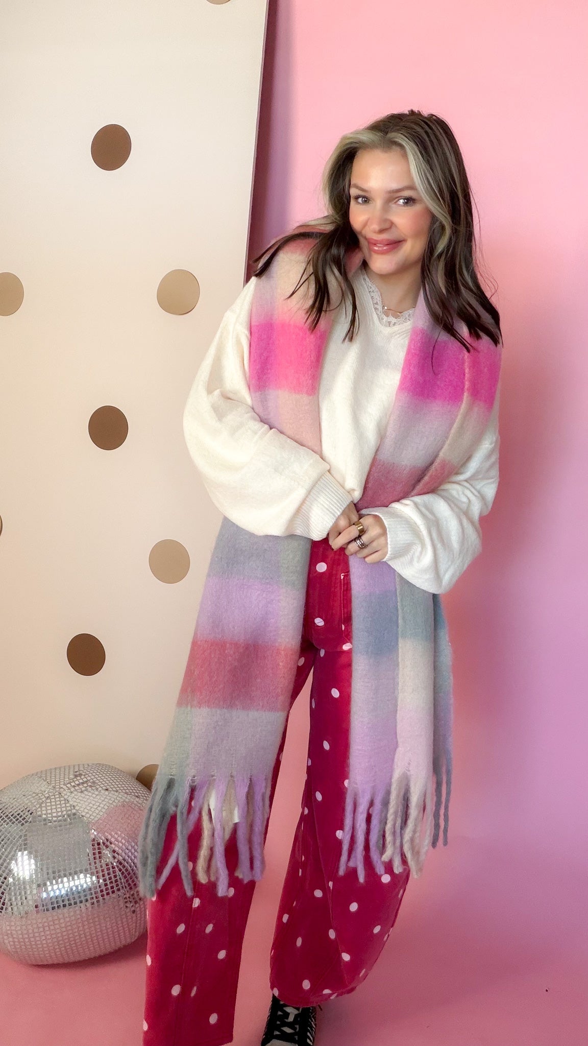 Joia plaid pink chunky scarf, model smiling with hands together