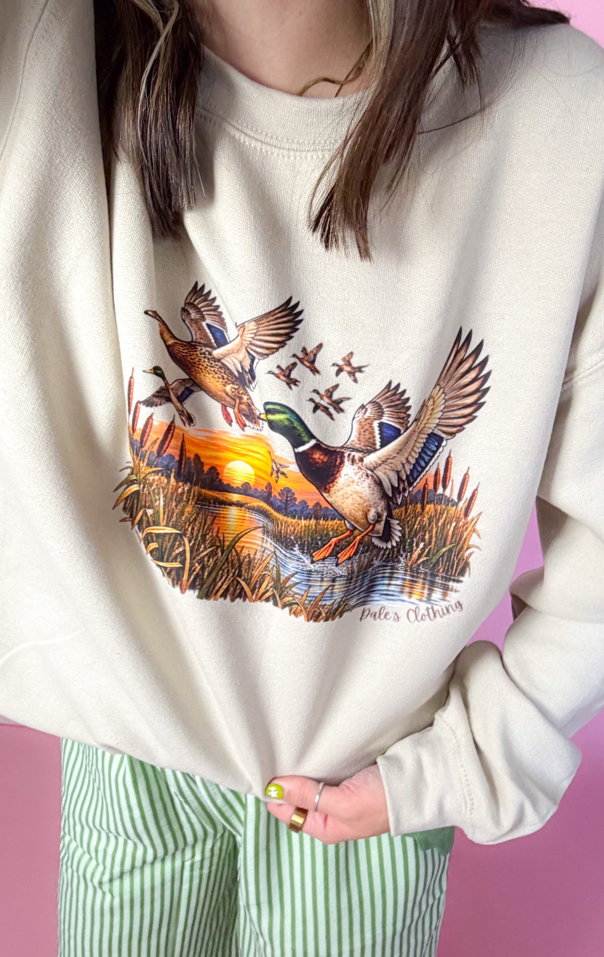 Entire Duck Crew sand sweatshirt, close-up of flying mallard graphic