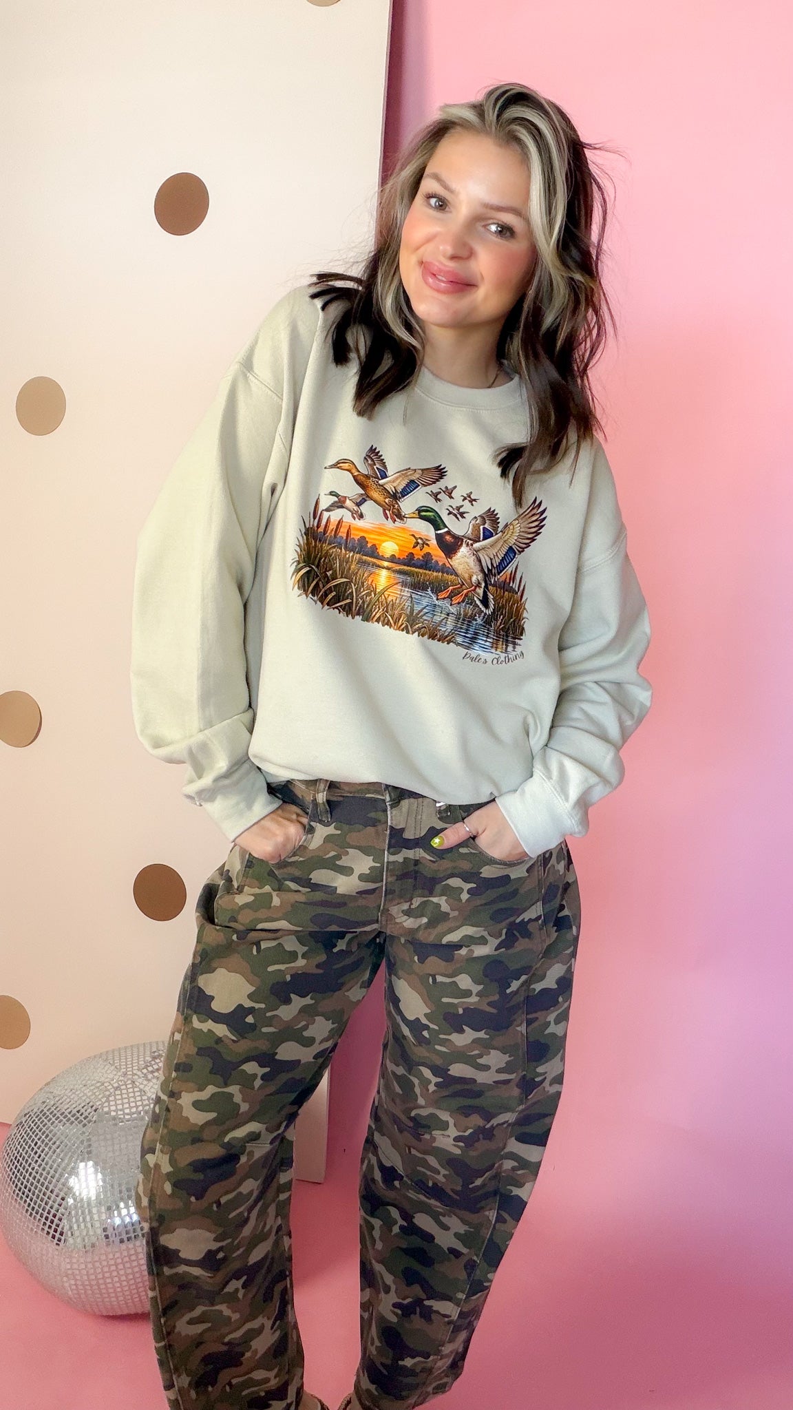 Entire Duck Crew sand sweatshirt with mallard graphic, front on model