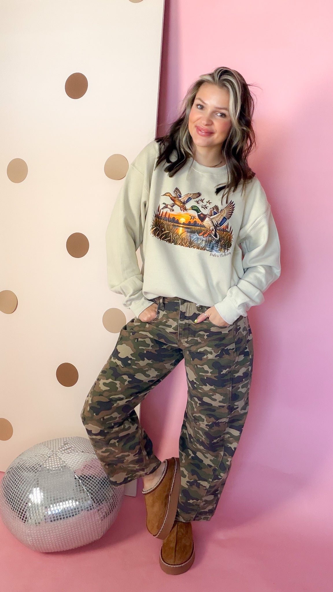 Entire Duck Crew sand sweatshirt, full-length front smiling on model