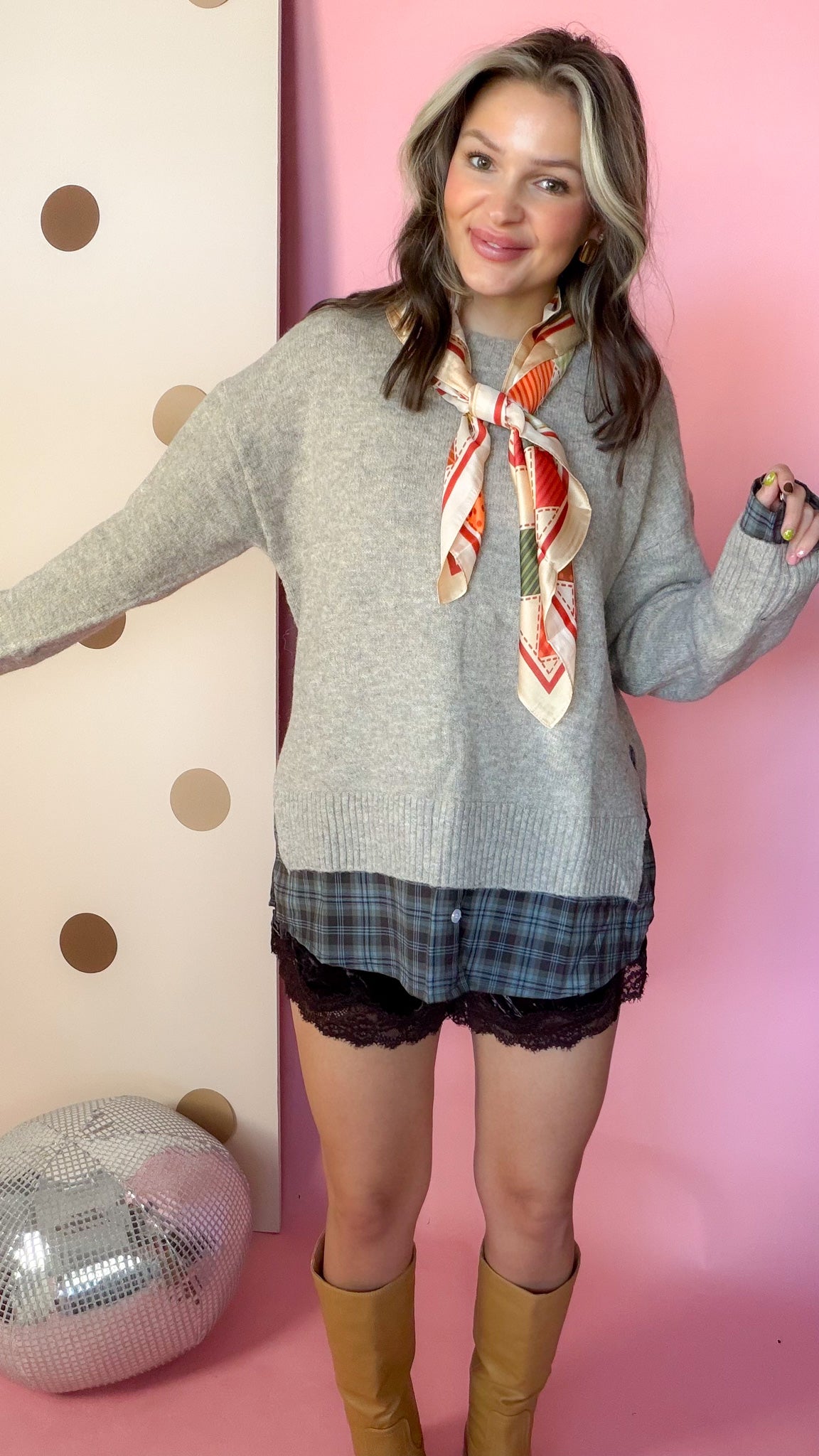 A Warming Welcome sweater, model smiling with arms out