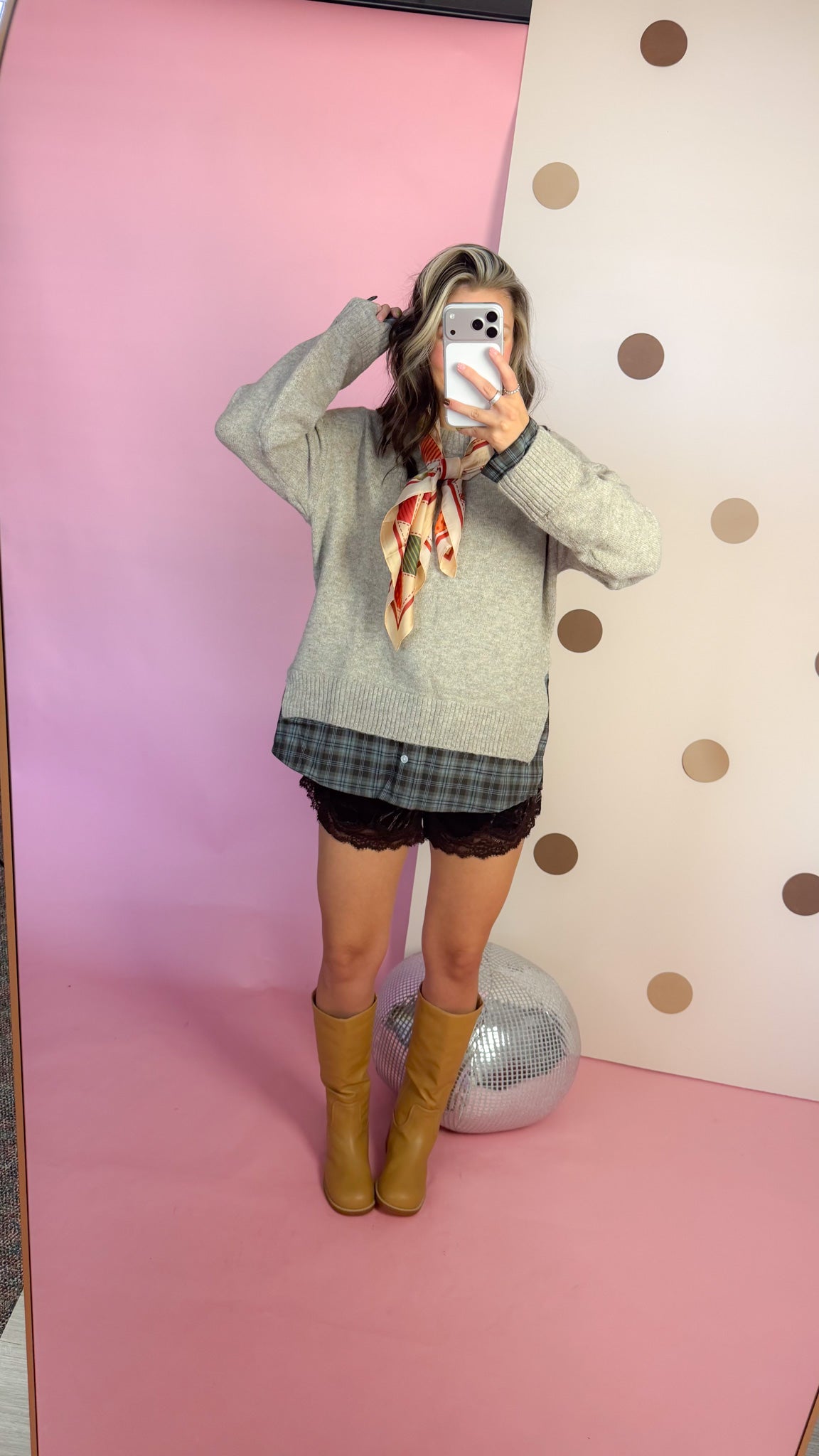 A Warming Welcome sweater, mirror selfie with hand raised