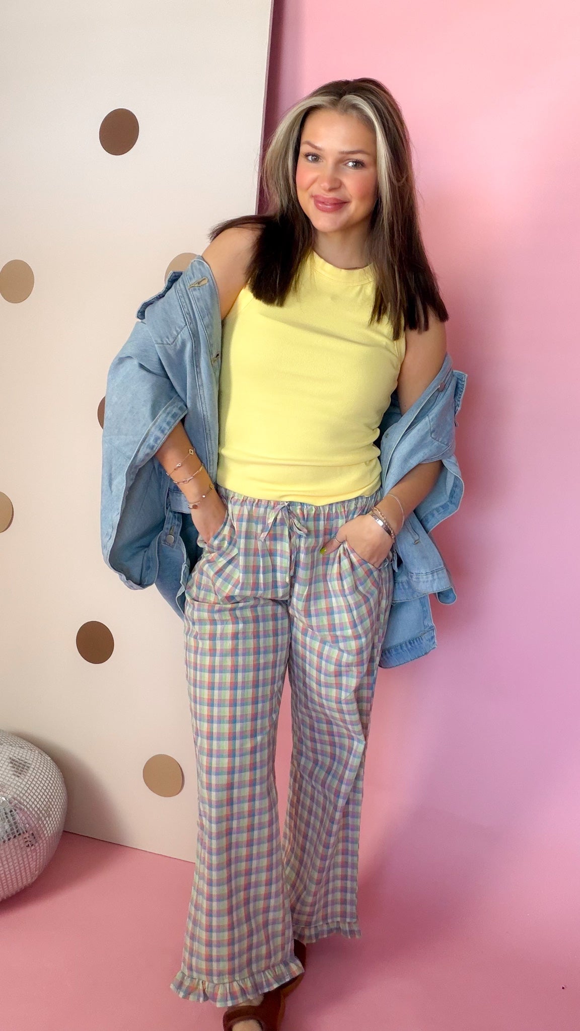 Front view of Daisy yellow tank top showing high round neckline and wide straps, denim shirt draped off shoulders.