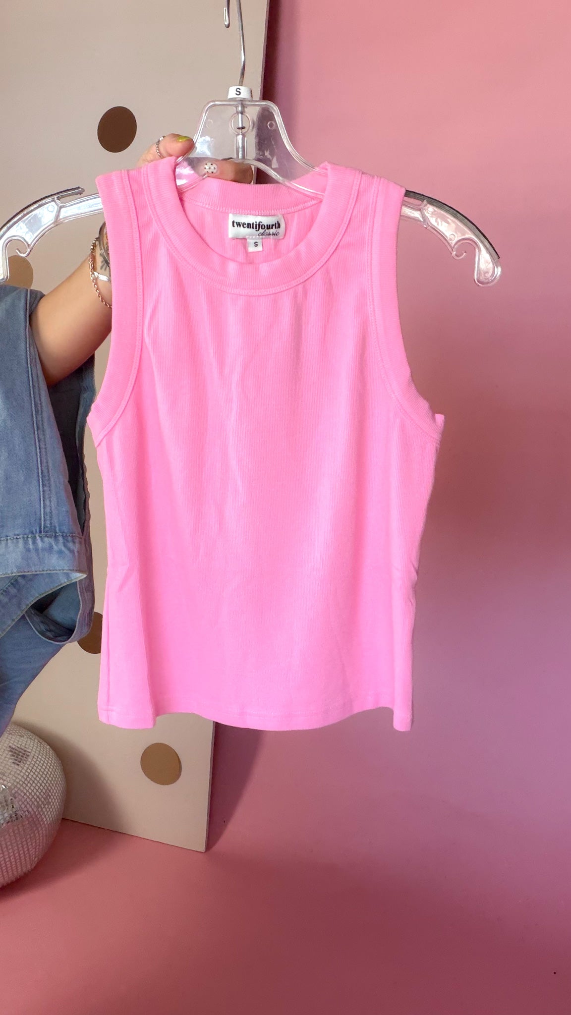 Close-up front view of hibiscus pink ribbed crop tank top with a round neckline and sleeveless silhouette.