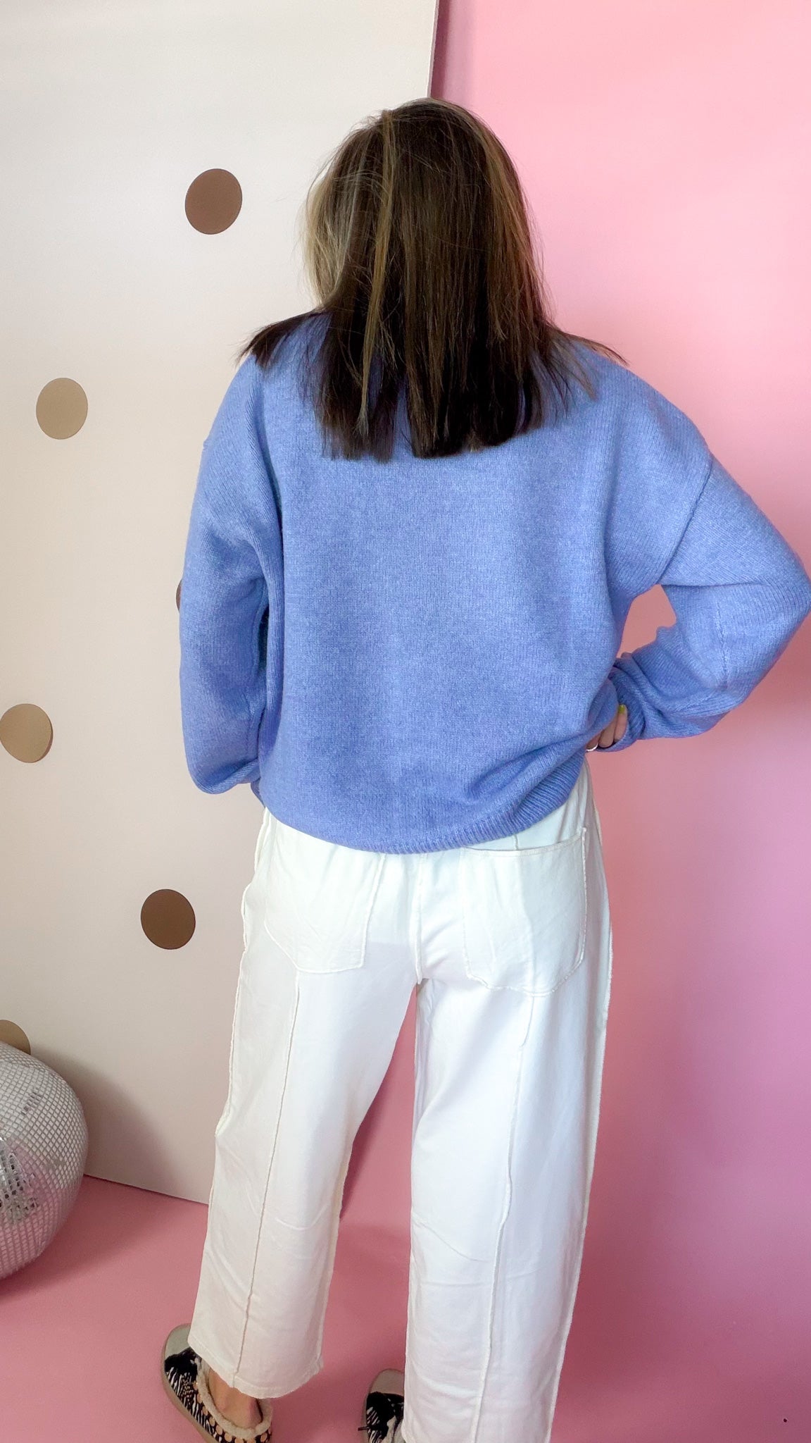 Back view of Ecru cotton barrel pants showing large back patch pockets and exposed seams.