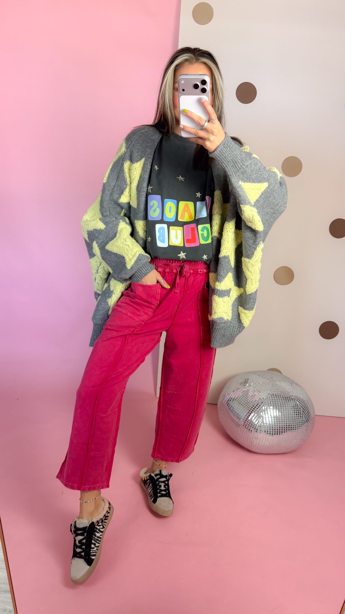 Full-length mirror view of Red mineral wash barrel pants styled with a gray star cardigan and sneakers.