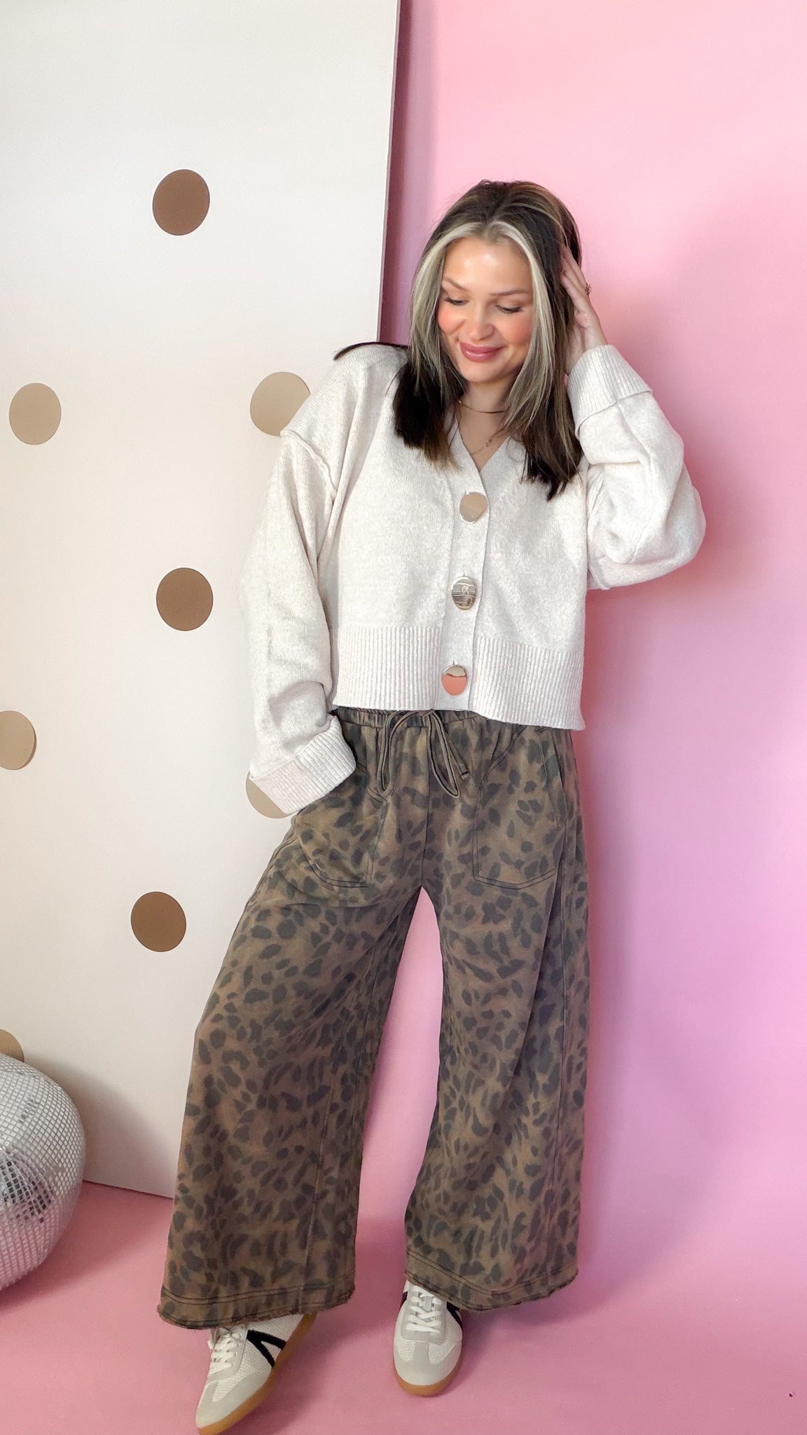 Model wearing mocha mineral-washed leopard pants with a cream cardigan, showing the relaxed wide-leg fit.