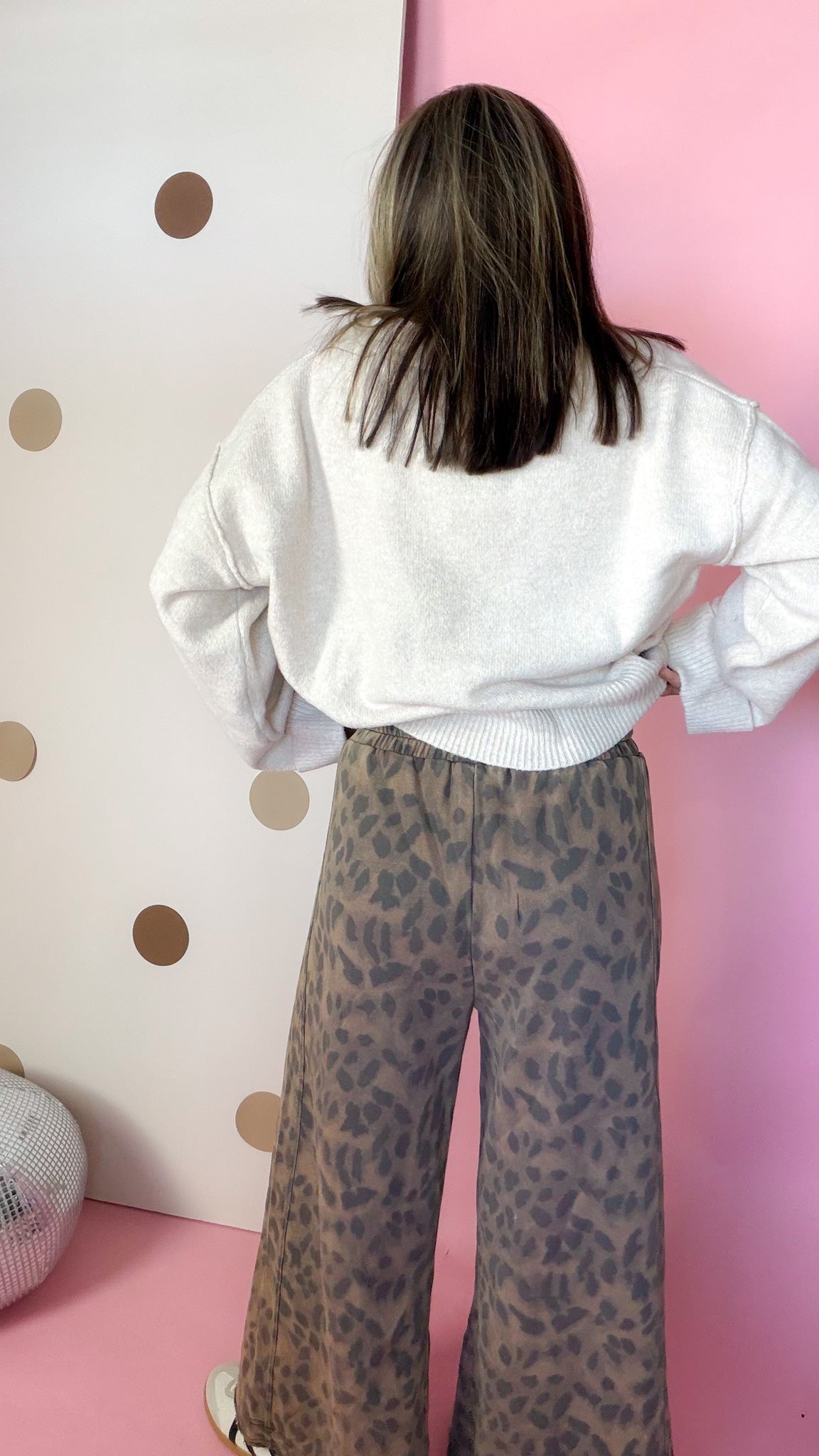 Back view of mocha leopard wide leg pants showing the elastic waistband and relaxed silhouette.