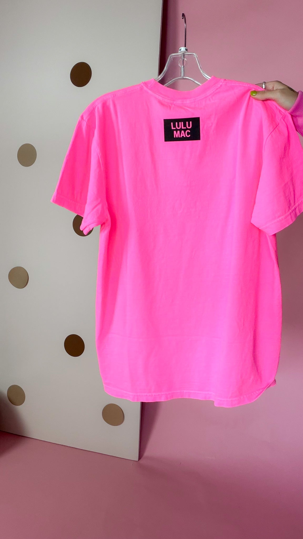 Back of Lulu Mac neon pink short-sleeve tee with a small black square LULU MAC logo below the neckline.
