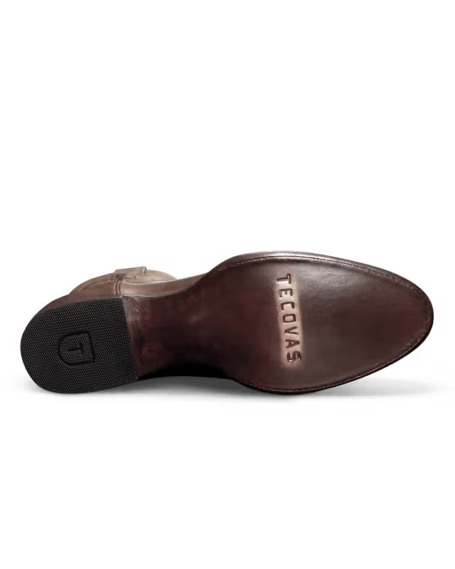 Brown leather shoe sole with 'Tecovas' branding on a white background