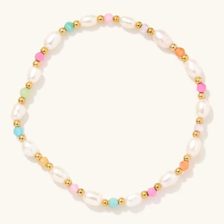 Freshwater pearl stretch bracelet with colorful beads and small gold-tone accents on a light background.