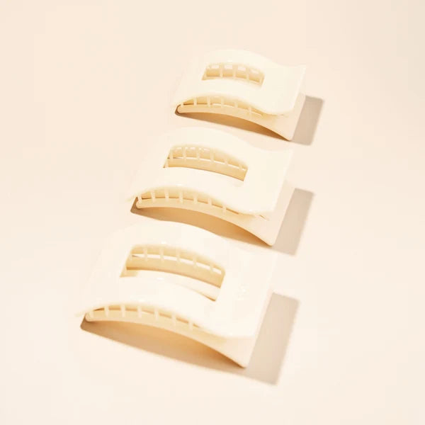 Three Teleties Almond Beige Flat Rectangle Hair Clips on a cream background