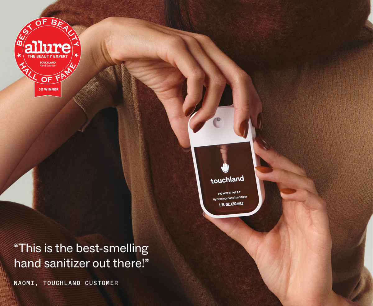Hand holding Touchland Salted Caramel Power Mist with Allure Best of Beauty badge