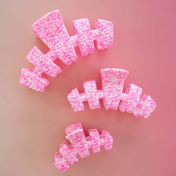 Teleties Breast Cancer Awareness claw clips in three sizes on pink, angled view