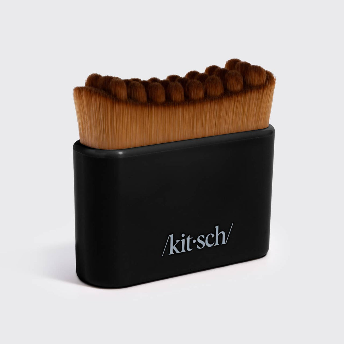 Kitsch Lymphatic Contour Face Brush in black, front view showing sculpted bristles