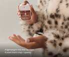 Touchland Midnight S'mores Power Mist being sprayed onto a hand, leopard faux fur coat