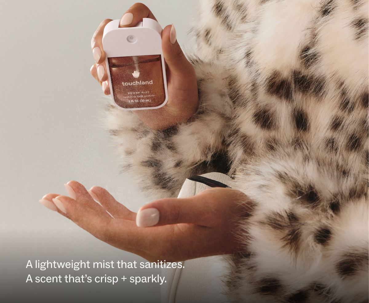 Touchland Midnight S'mores Power Mist being sprayed onto a hand, leopard faux fur coat
