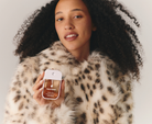 Model in leopard faux fur holding Touchland Midnight S'mores Power Mist