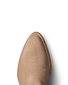 Tan cowboy boot with detailed stitching on a white background. Tecovas women’s cowboy boots