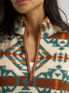 Close-up of the Wrangler Sherpa Pullover's rust-trimmed half zip collar