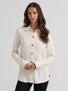 Wrangler women's Western long sleeve concho shirt in white, front view on a model
