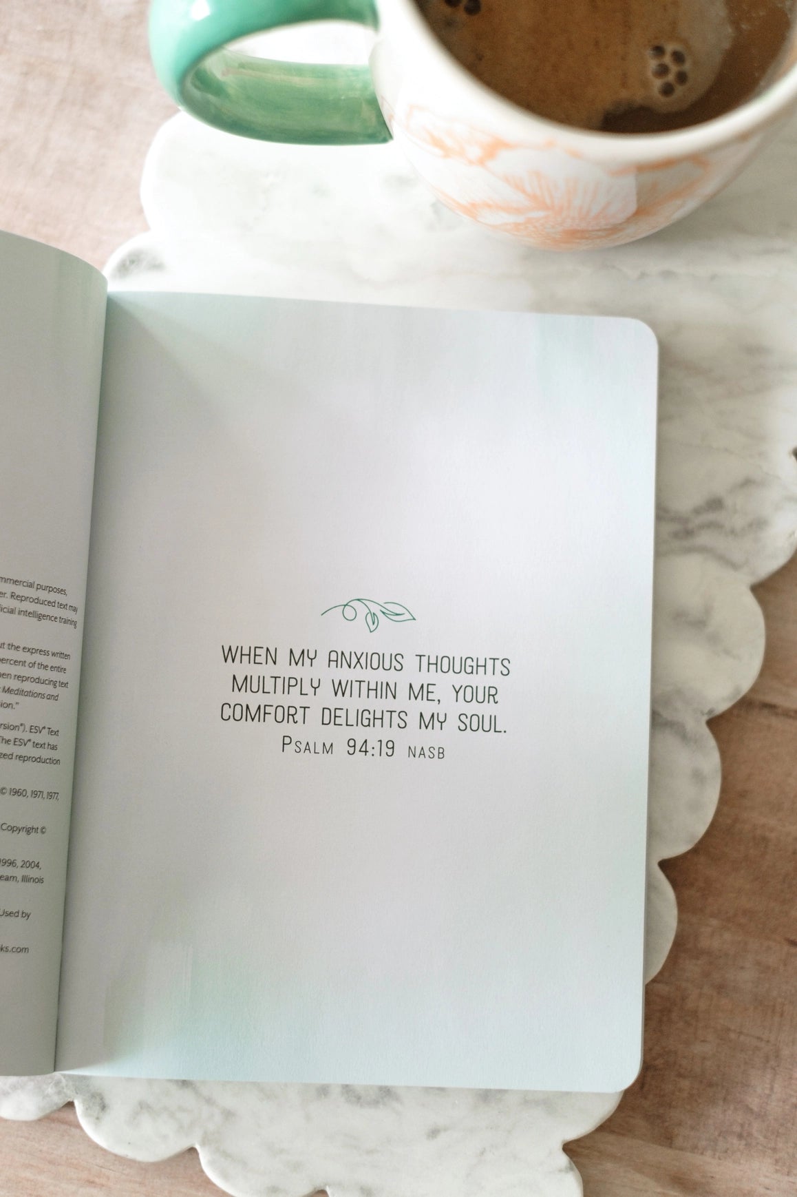The Overthinker's Devotional Journal, open to a Psalm 94:19 verse page beside coffee