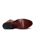 Close-up of a brown leather shoe sole with 'Tecovas' branding on a white background