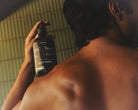 Preston Green Tea and Bergamot Body Wash bottle held against a man's shoulder