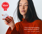 Model holding Touchland Cranberry Fizz Power Mist with Allure Best of Beauty badge