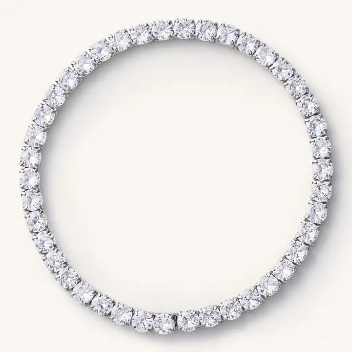 Silver-tone elastic tennis bracelet with a continuous row of clear round stones, viewed from above.