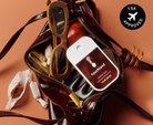 Touchland Salted Caramel Power Mist in an open brown handbag with TSA approved badge
